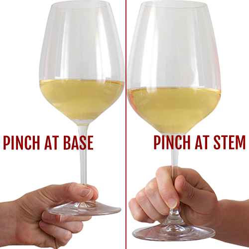 Hold the glass from its stem or base